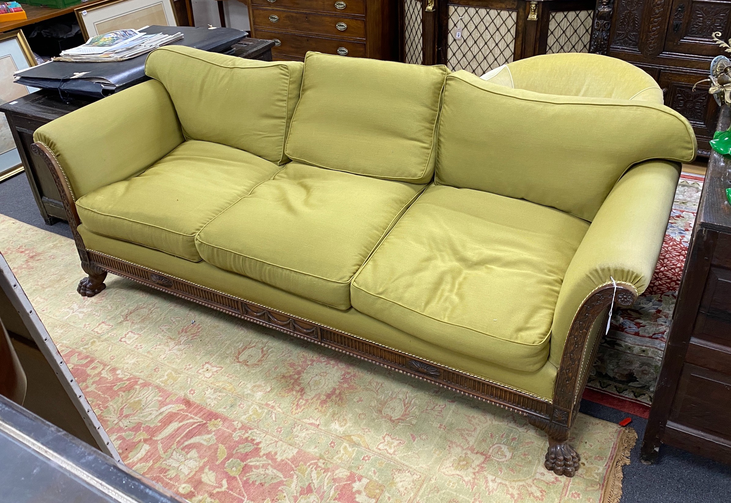 An early 20th century mahogany three-seater settee on claw feet, length 220cm, depth 86cm, height 80cm